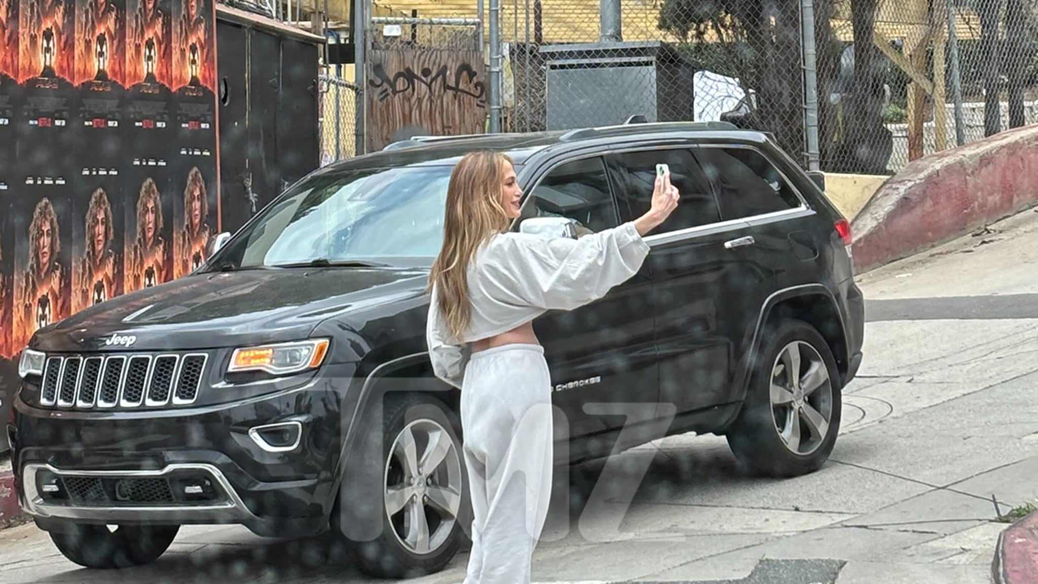Jennifer Lopez Takes Selfies in Front of Her Own ‘Atlas’ Billboard